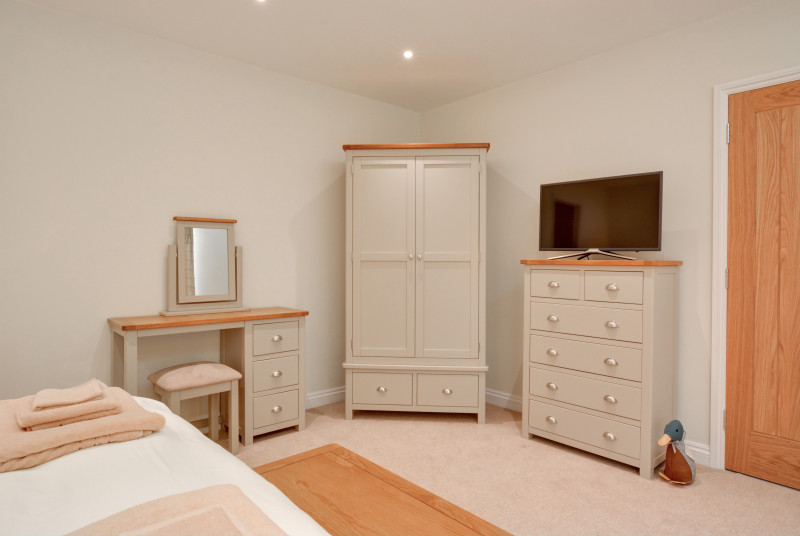 View of bedroom furniture and TV