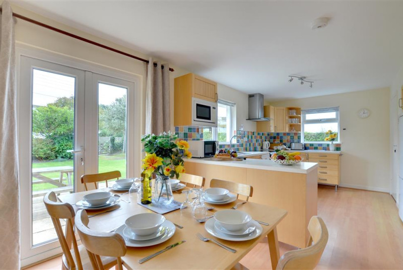 The spacious modern dining kitchen has patio doors out into the garden