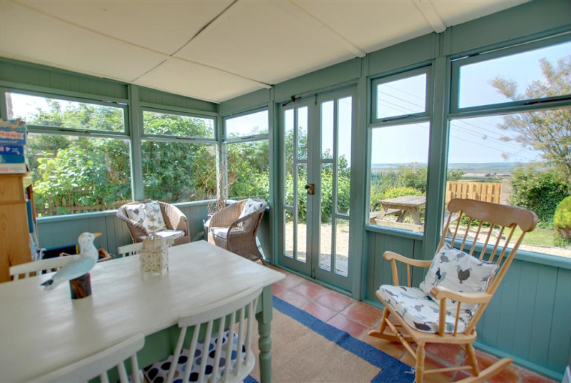 The cottage benefits from a lovely conservatory with doors leading to the patio area
