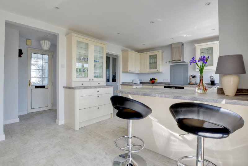 The modern well equipped kitchen area has a small breakfast bar and overlooks the rear garden