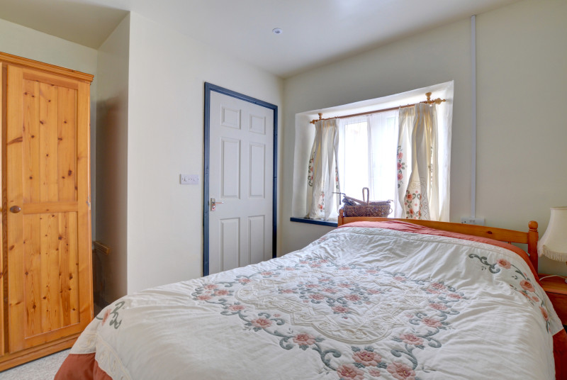 A compact double bedroom but with clear access between door, bed and wet room