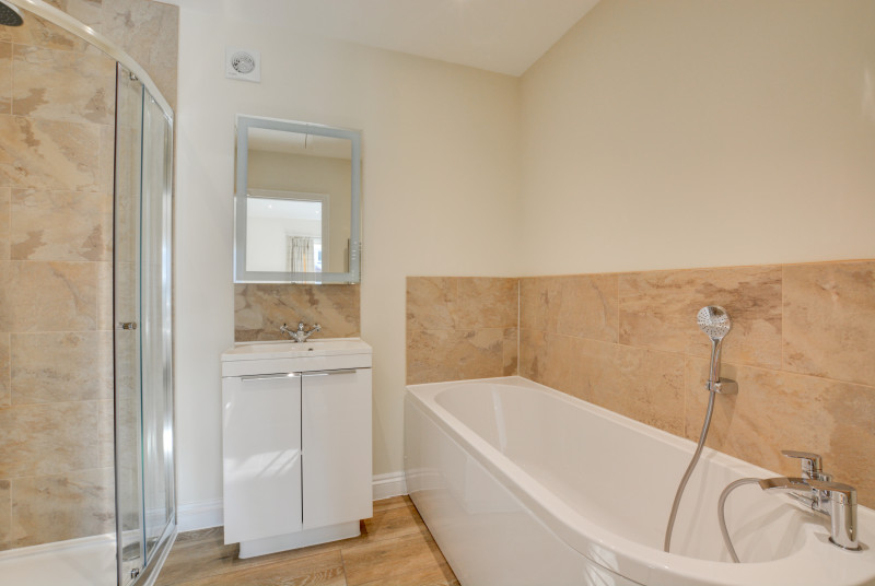 En-suite to bedroom 1 with vanity unit, both and shower