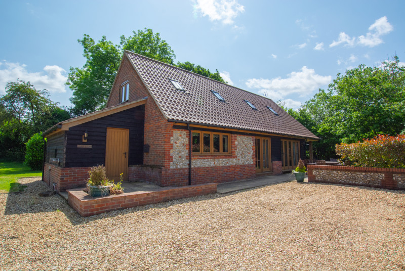 Outside view of property showing gravel driveway.