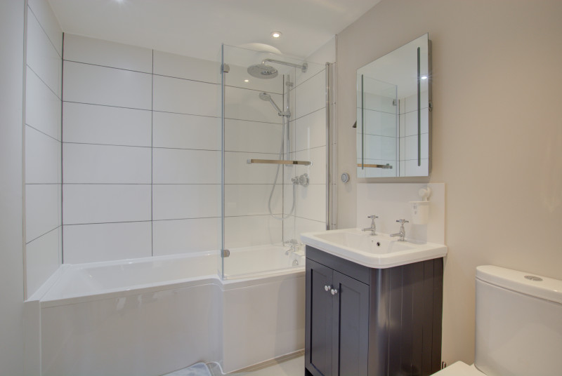 Bathroom with bath, overhead shower, washbasin & wc