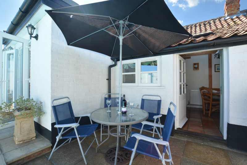 Lovely patio area with furniture and parasol