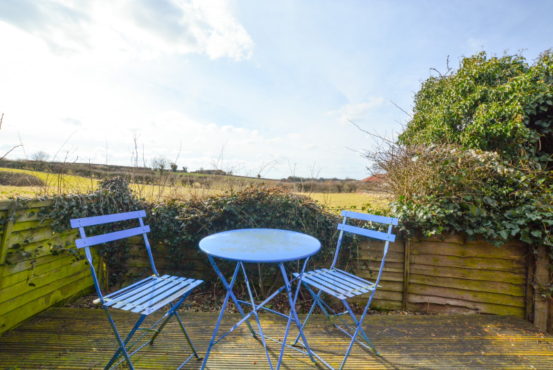 Decking area with garden furniture and countryside views