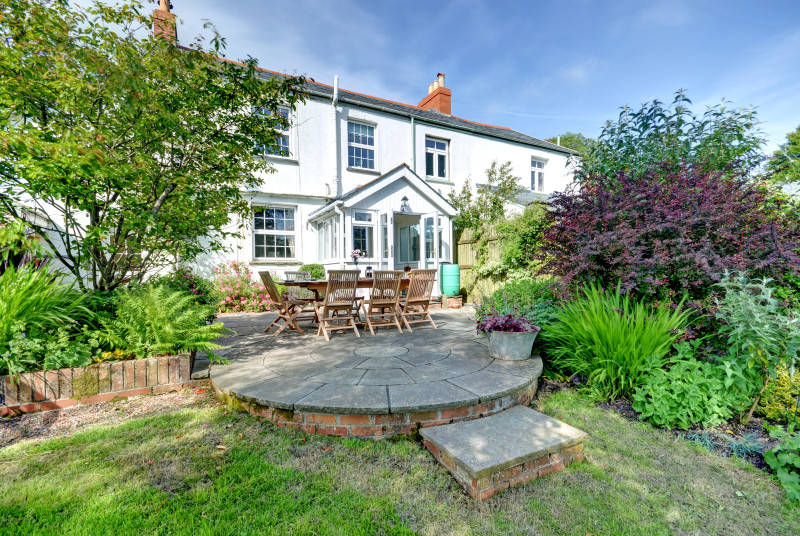 The patio area with steps down to the garden