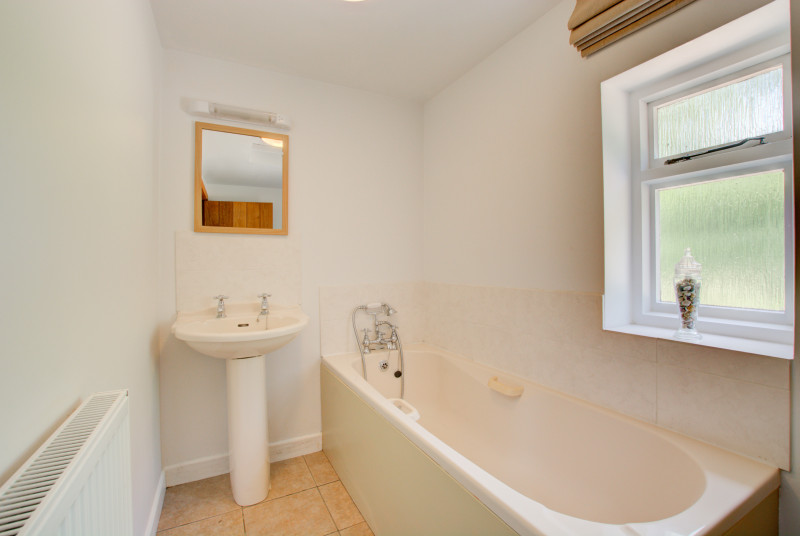 Bedroom 2 En-Suite with bath, hand held shower, washbasin and wc
