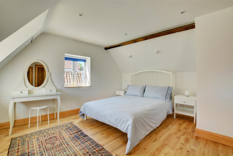 Spacious bedroom with king sized bed and en suite shower room