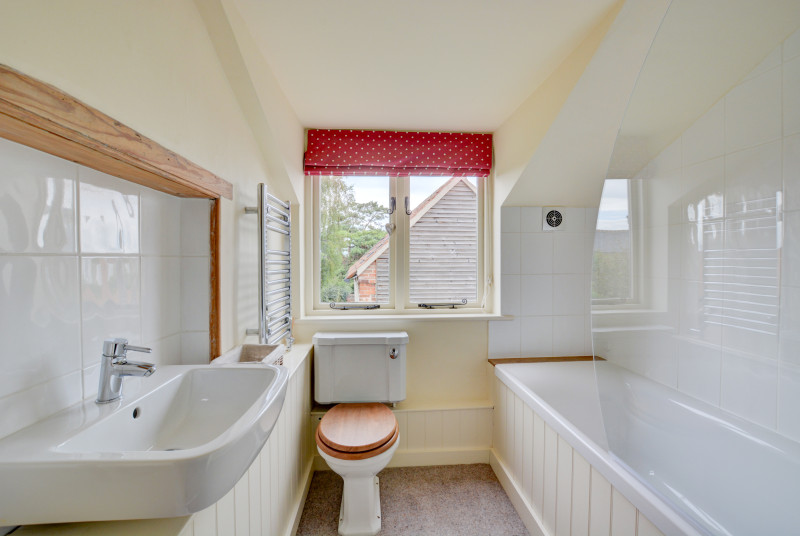 Bathroom with bath, over bath shower, washbasin and wc