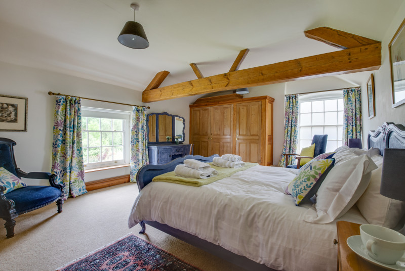 Large bedroom with king size bed and wooden beams