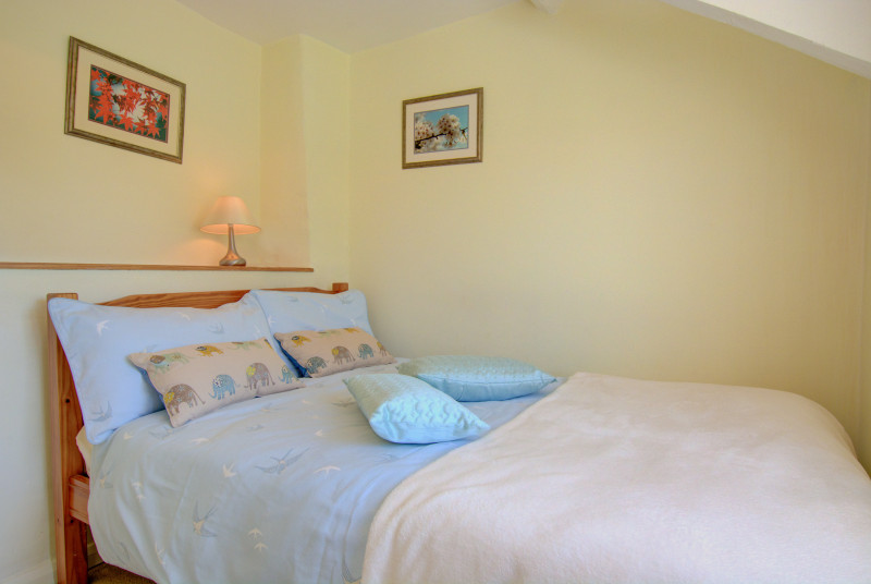 A smaller double bedroom with a 4ft double bed 