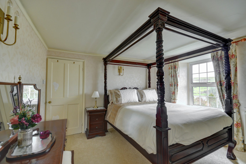 The beautiful master bedroom with King four poster, dressing area and en suite bathroom