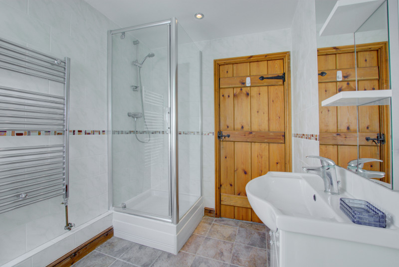 Shower cubicle and heated towel rail.