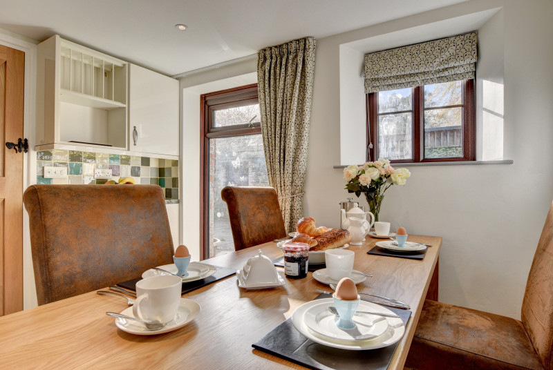 The kitchen benefits from a large dining table which comfortably seats six