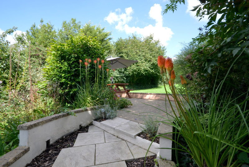 Steps lead up to the large enclosed garden with patio area, picnic bench and a good sized lawned area, ideal for children’s play