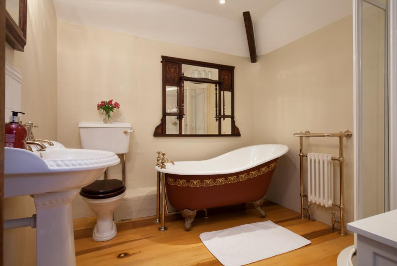 A Traditional Family Bathroom with roll top Bath and Separate Shower cubicle