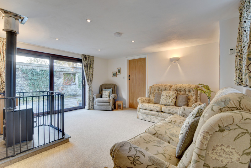 The barn has a lovely open plan living room with patio doors leading onto a large and fully enclosed sun trap courtyard