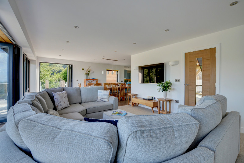 Stunning sitting room with ample seating and huge windows to enjoy the spectacular views