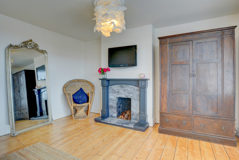 Feature fireplace in second floor bedroom with king-size bed
