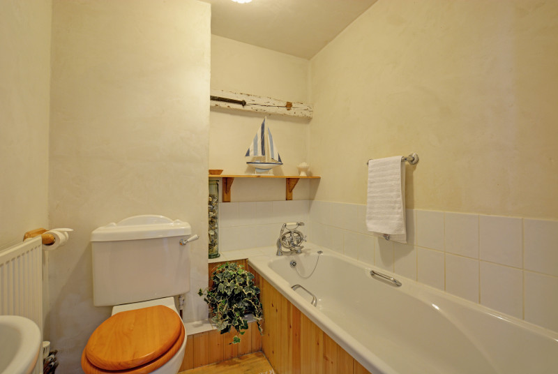 Bathroom with bath and handheld shower