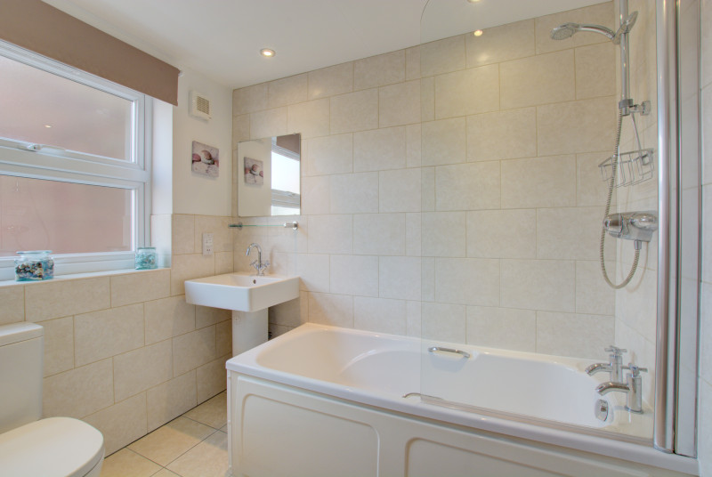 Sparkling white bathroom, heated towel rail.