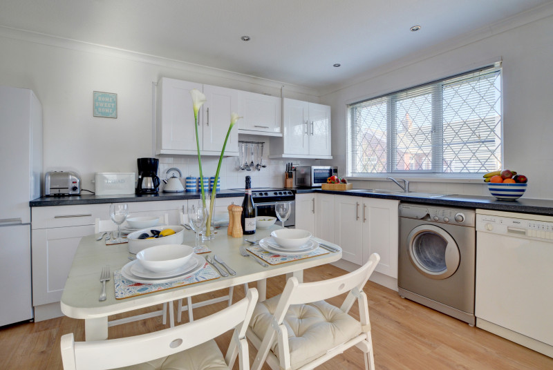 The well equipped kitchen with dining table