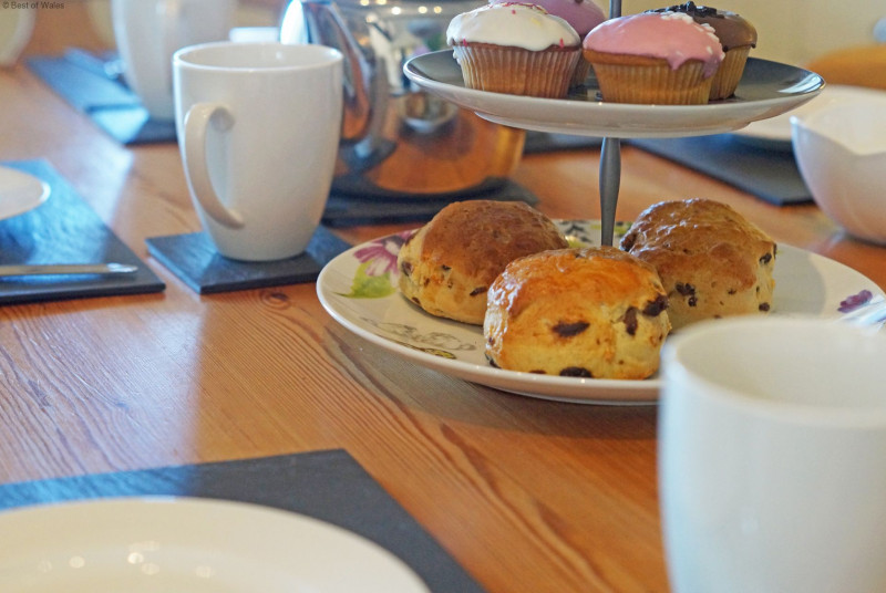 A spacious, cream 'shaker' style kitchen with a farmhouse pine table.