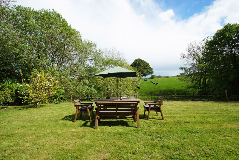 Garden furniture in a private setting with countryside views.