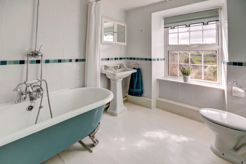 Spacious family bathroom with roll top bath
