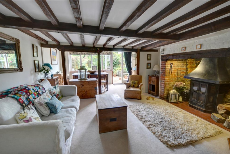 Comfortable, beamed sitting room with feature fireplace