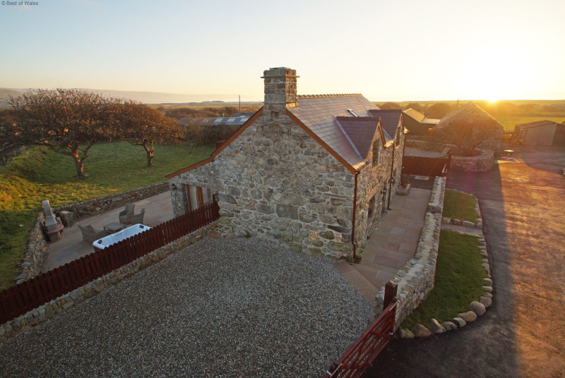 Hafod cottage with the sun setting over the sea
