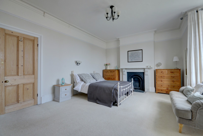 The spacious master king bedded room can be found on the first floor, with sofa in a large bay window and distant sea views across the burrows