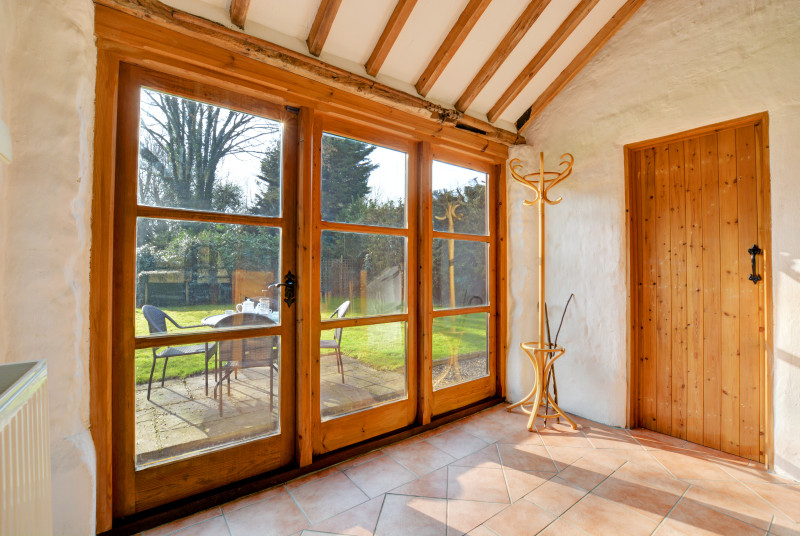 Glazed doors from the hall open into the rear garden