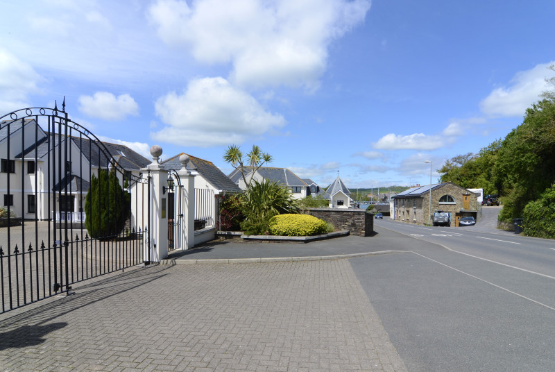 Secure gated entrance to self-catering apartments in Kingsbridge with private parking and estuary views
