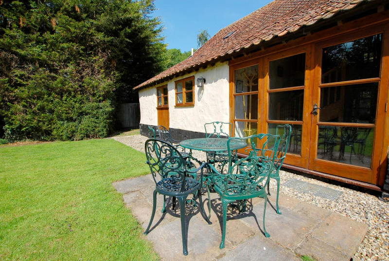 Seating area in the rear garden is perfect for al fresco dining