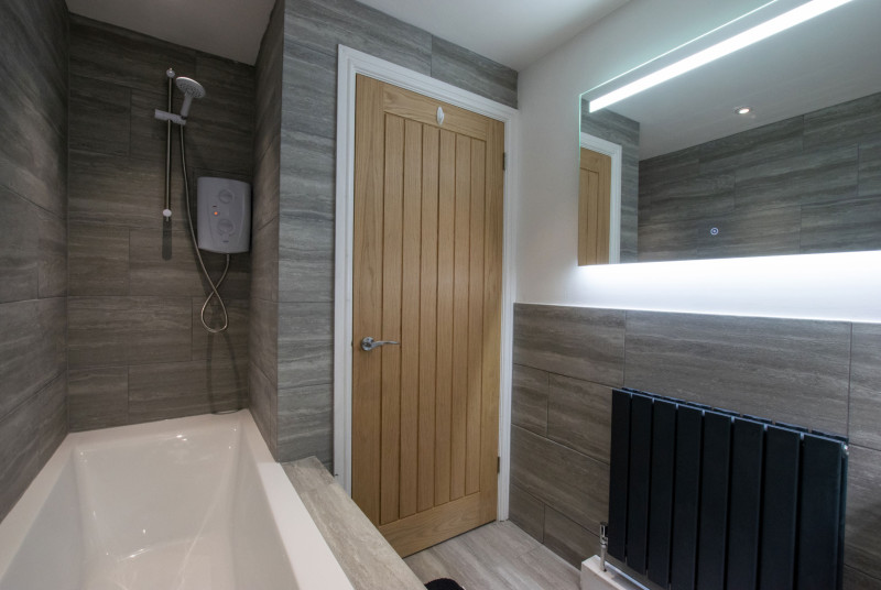 Master Bathroom with bath and shower over bath