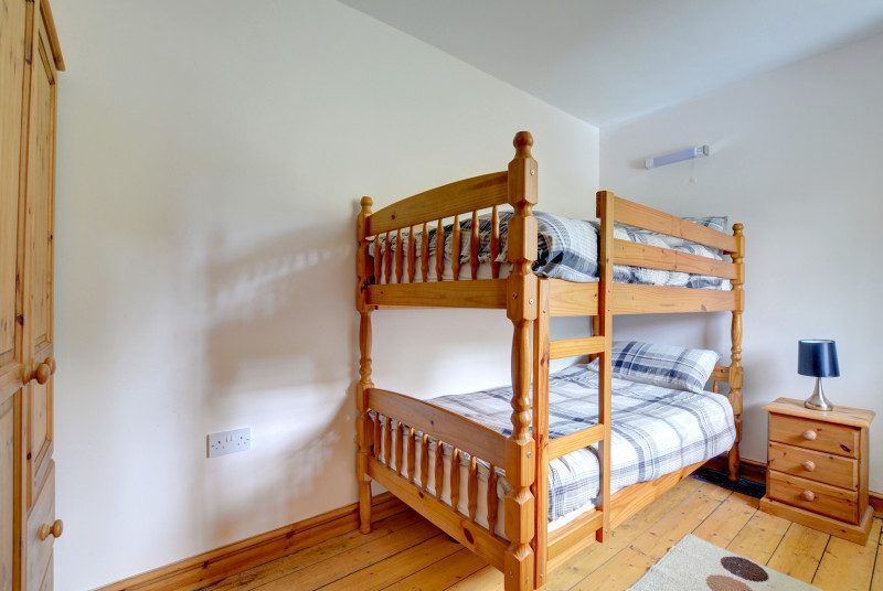 Bunk Bedroom with full sized bunks and pine furniture
