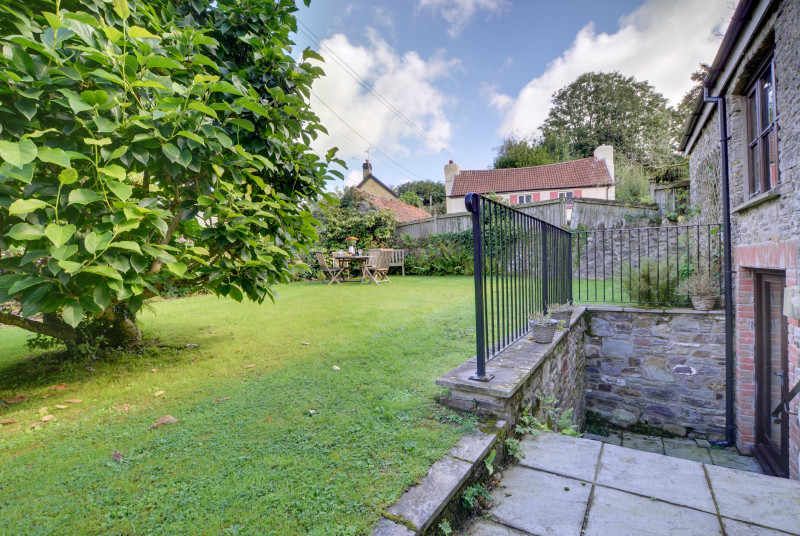 Steps lead up to a quiet lawned courtyard garden