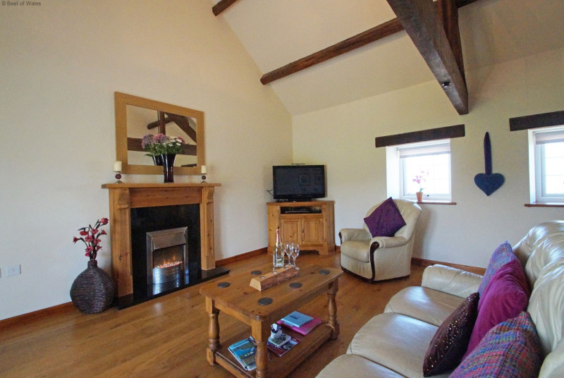 Living room with solid oak floor and comfortable, large leather sofas