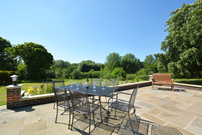Patio with table and chairs - perfect for dining alfresco on a warm summer evening!