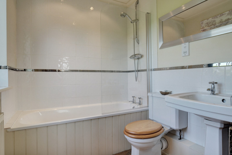 En-suite, bath with shower over, washbasin and wc
