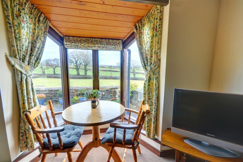 Dining area in the conservatory with open countryside views.
