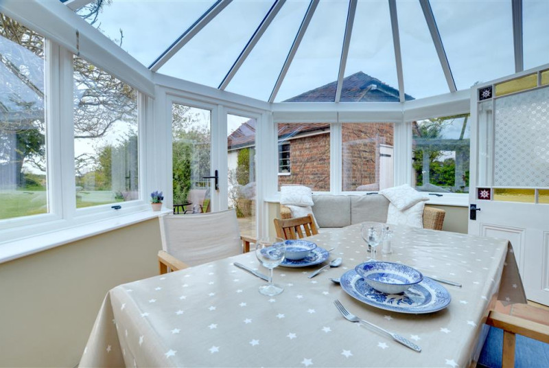 The conservatory doubles up as a wonderful dining space.