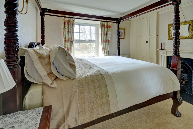 Wooden four poster bed in the master bedroom