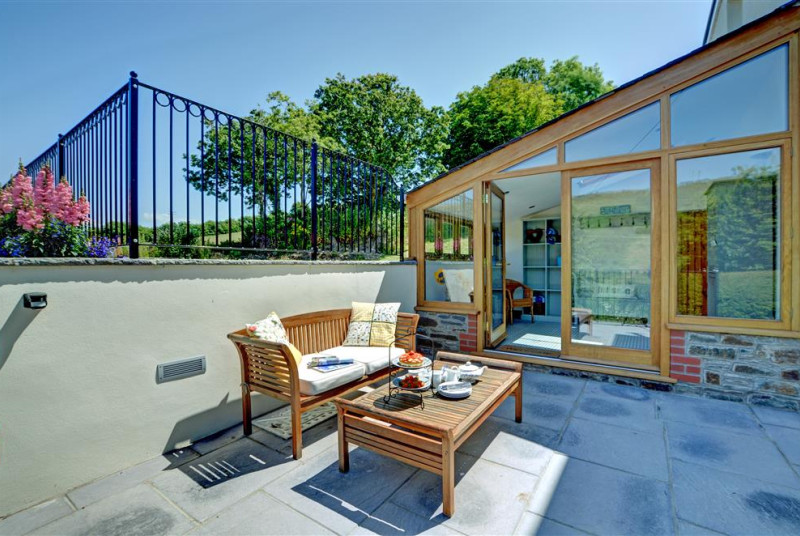 Front patio area with outside sofa and coffee table