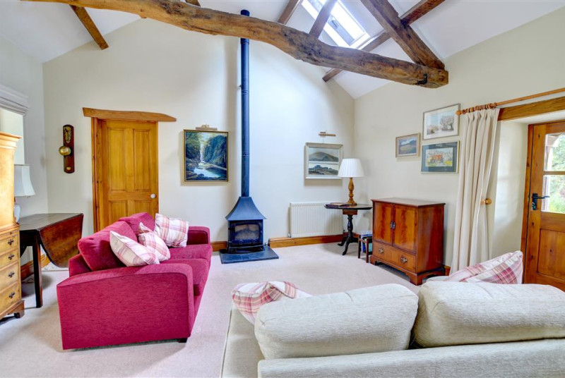 The comfortable sitting area has two good sofas and a woodburning stove