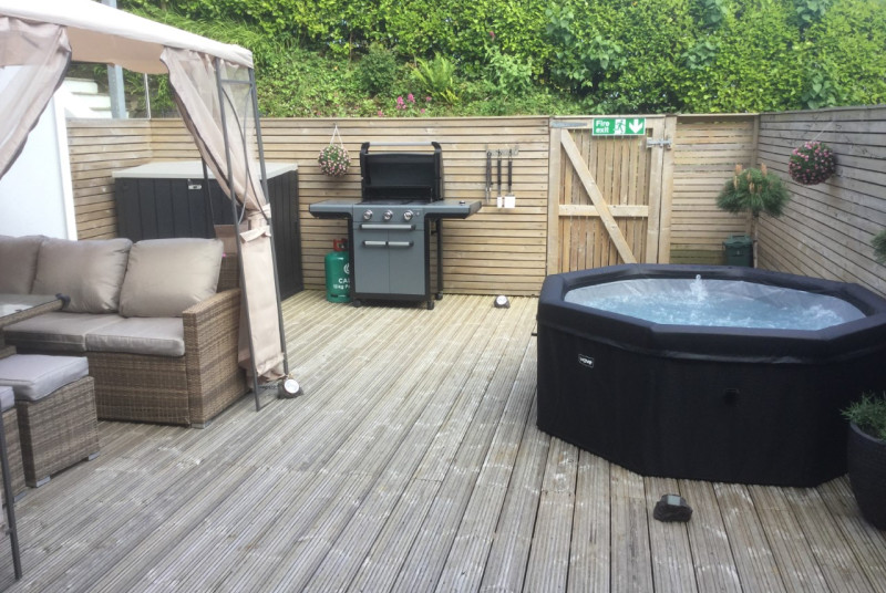 Large balcony area at Neptune , Saundersfoot with Gazebo over large Rattan furniture, BBQ,  ice bucket and hot tub