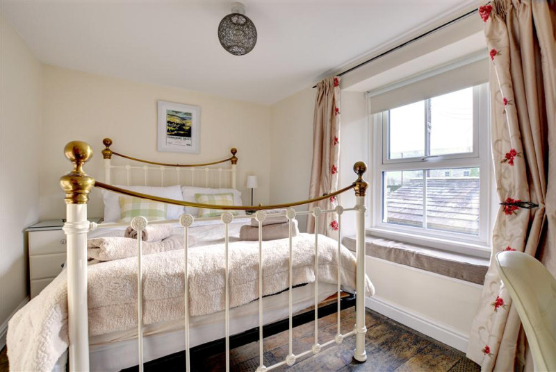 Bedroom 1 has a lots of character with its cast iron bed.