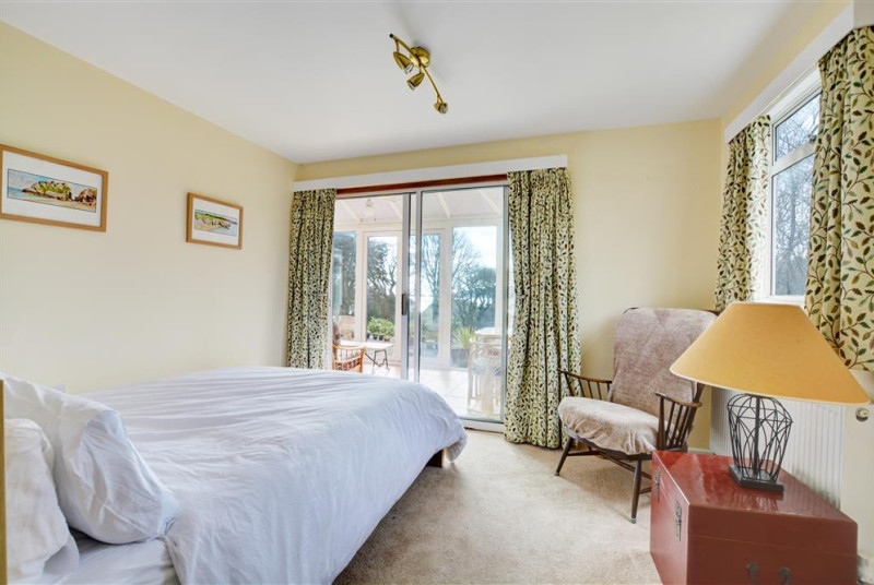 Master double bedroom with ensuite bathroom leading to convervatory and sea views